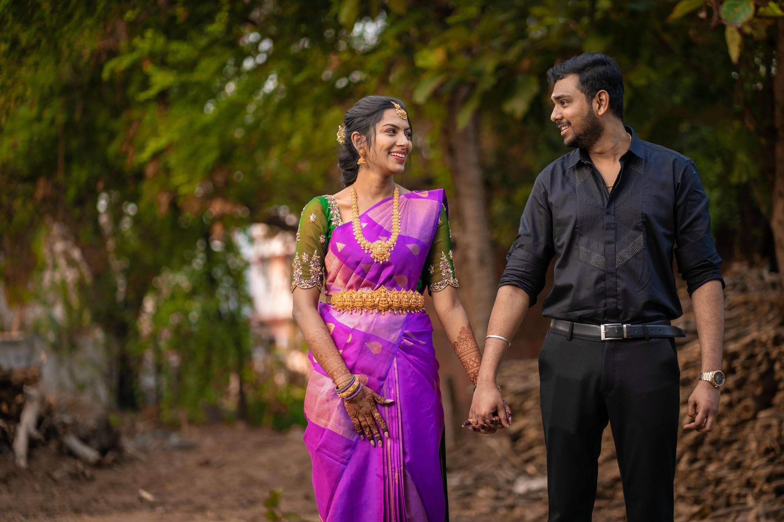 Couple walking hand in hand through nature