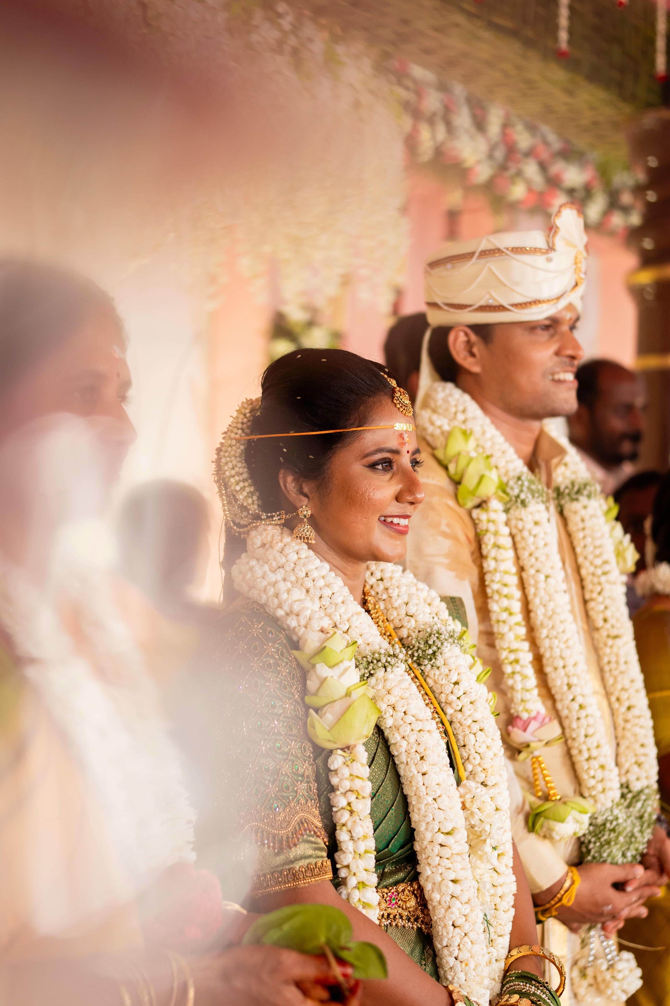 Couple wearing traditional wedding attire in outdoor setting