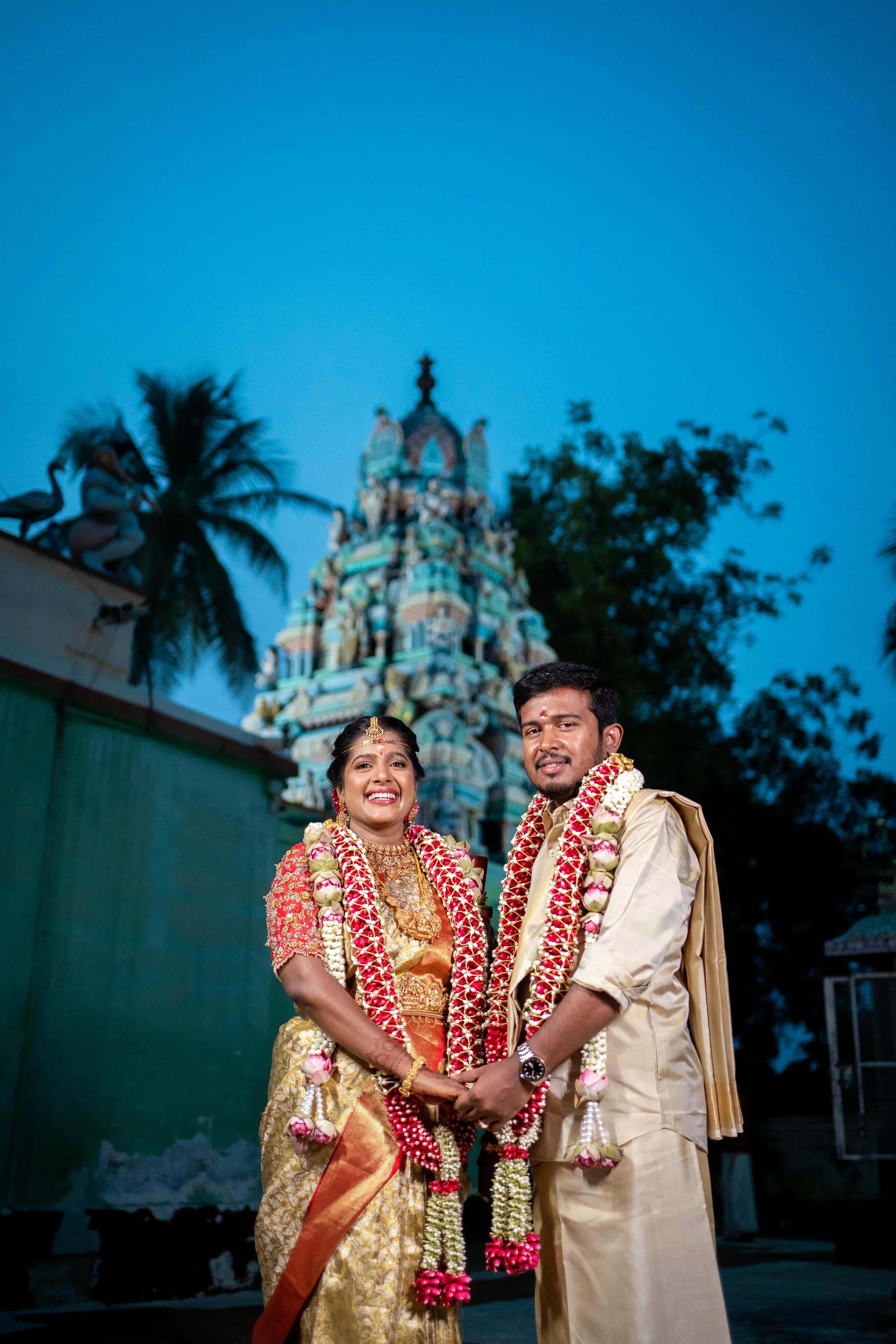 Wedding traditional photography with couple posing in temple background