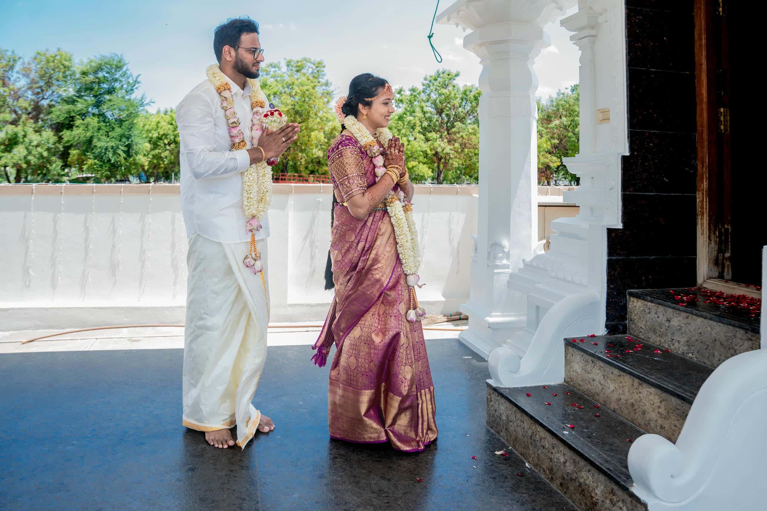 Traditional wedding photos of a Tamil bride and groom praying together