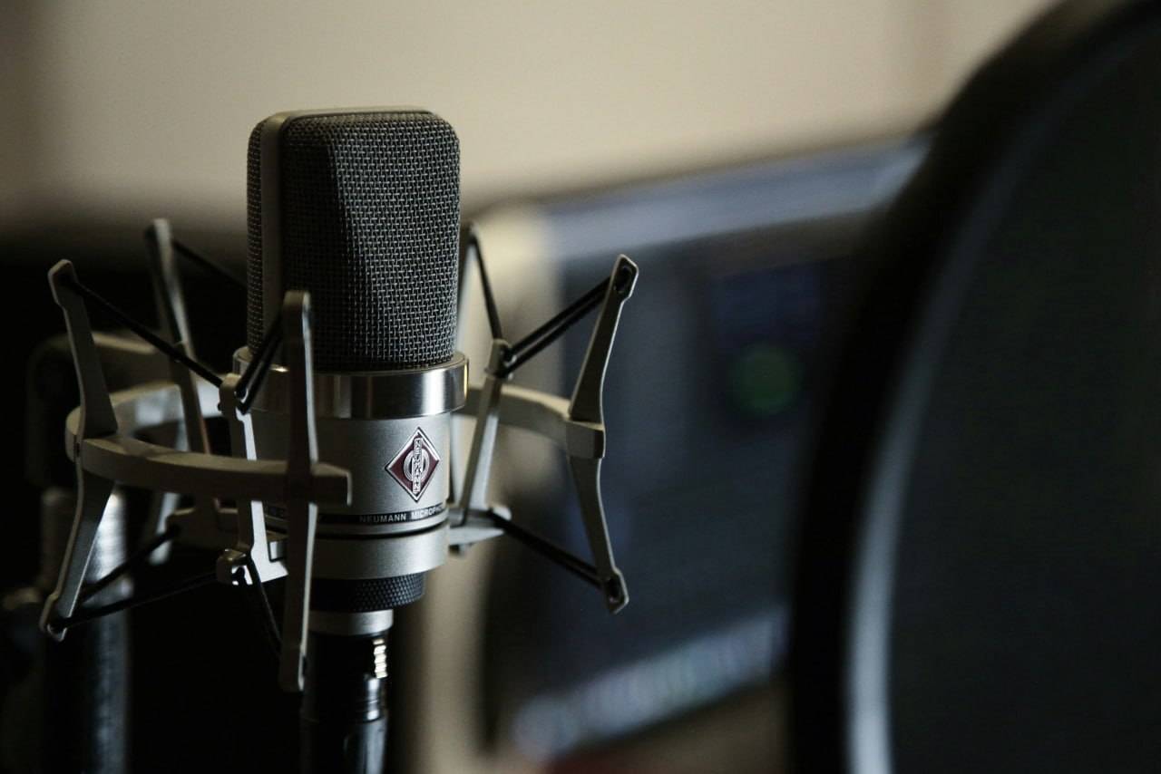 Podcast recording microphone in a professional podcast studio background setup
